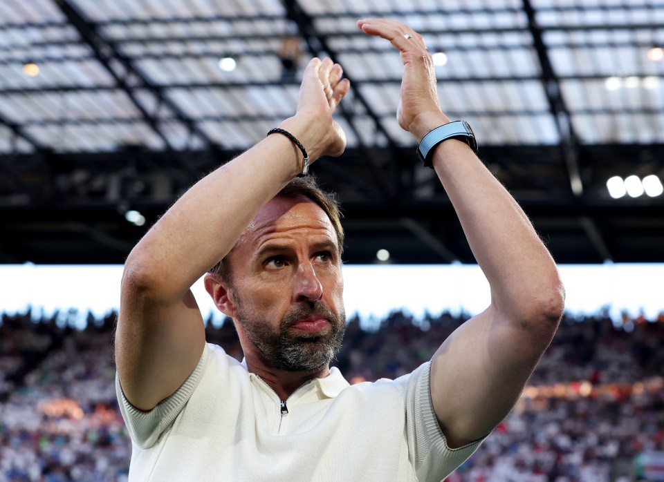 a man in a white shirt is clapping his hands in the air