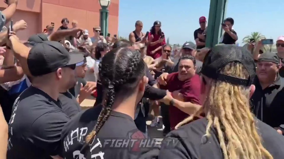 A man dressed in maroon fought back after a punch was thrown in his direction