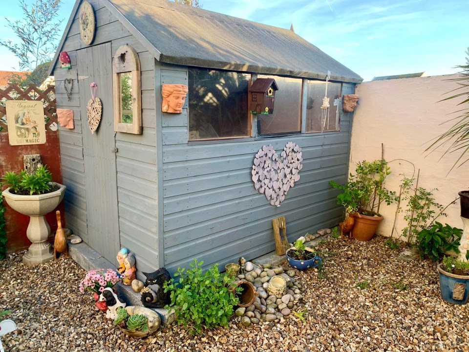 Even the shed which sits in the corner isn't an eye sore because of the pastel paint and ornaments