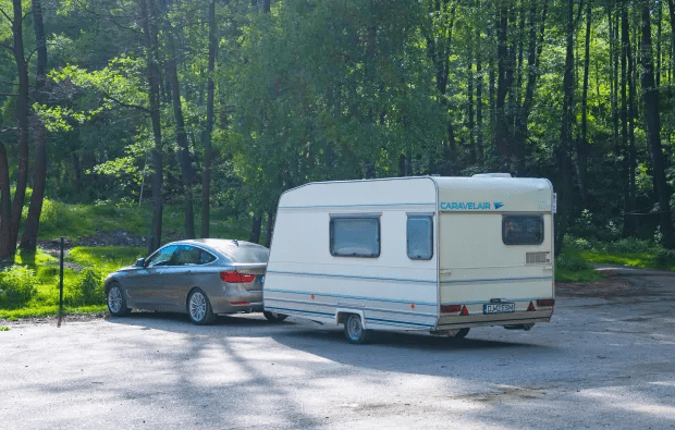 This caravan would not be legal on UK roads as the rear plate must be yellow with black lettering