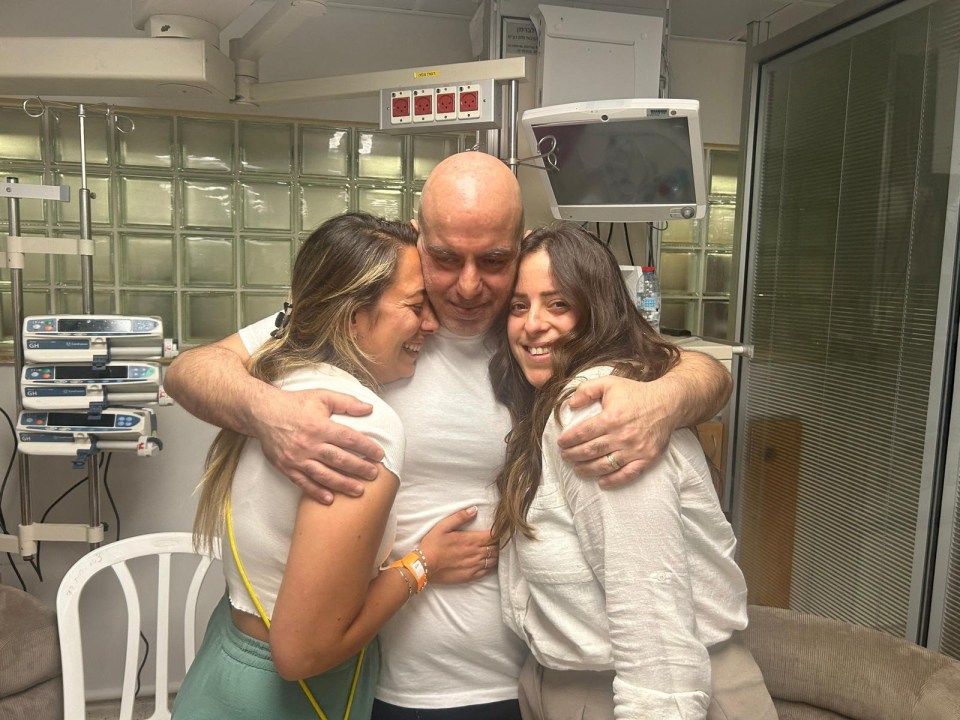 Shlomi Ziv, a rescued hostage embraces his sister, Revital Nasi, and his cousin, Liat Ariel