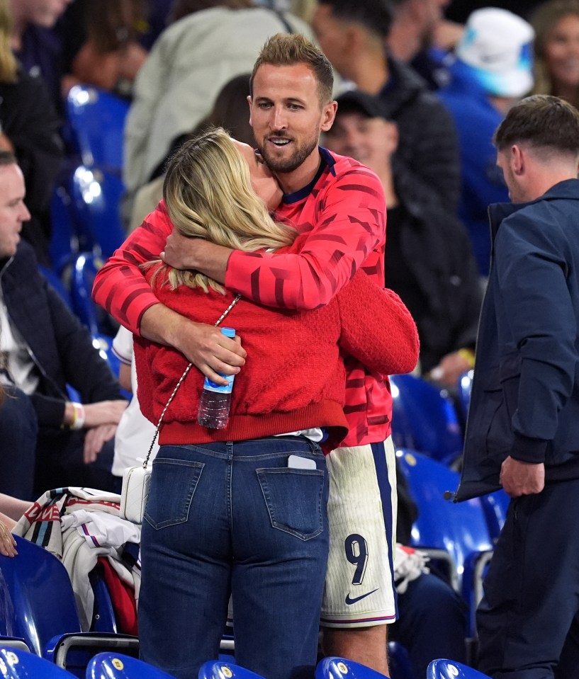 Kane hugs wife Kate Goodland after the narrow win