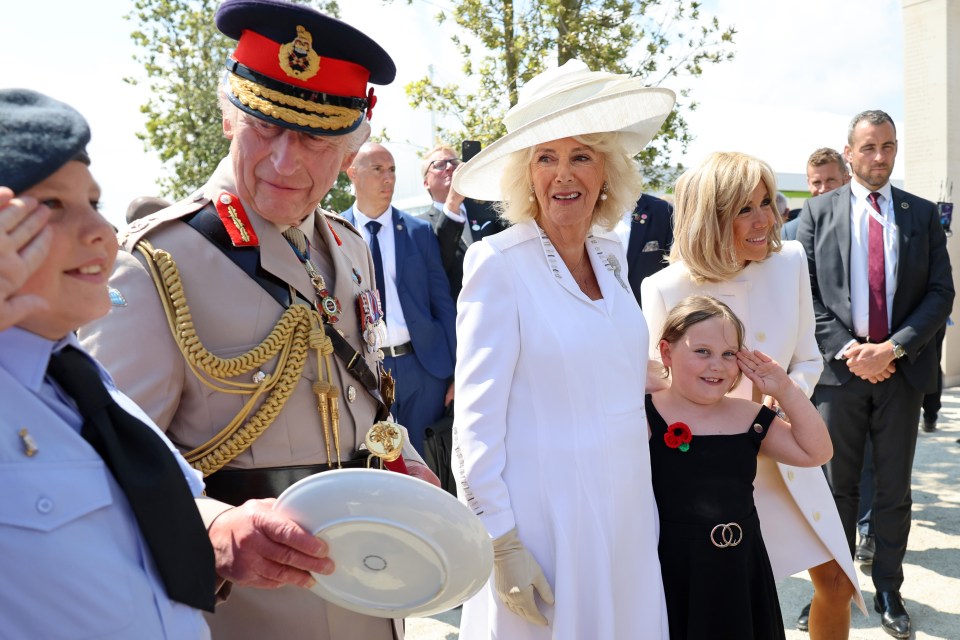 Cheeky air cadet Toby Guy, 13, and sister Ellie Mae, seven, grabbed a picture with the King and Queen and France's First Lady Brigitte Macron