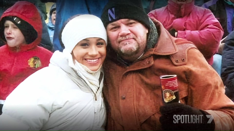 a man and a woman are posing for a picture and the man is wearing a hat with the letter n on it