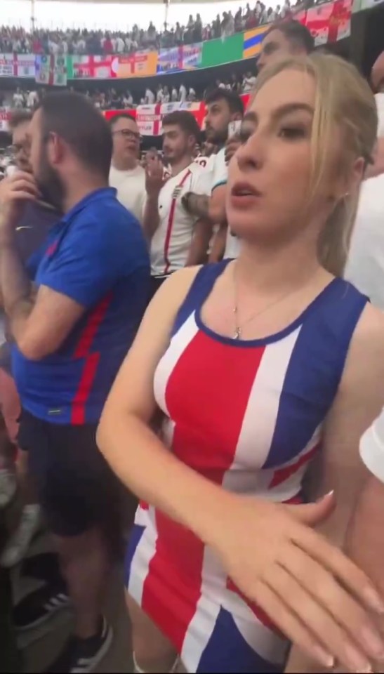 A clip has now emerged of someone throwing a beer over her