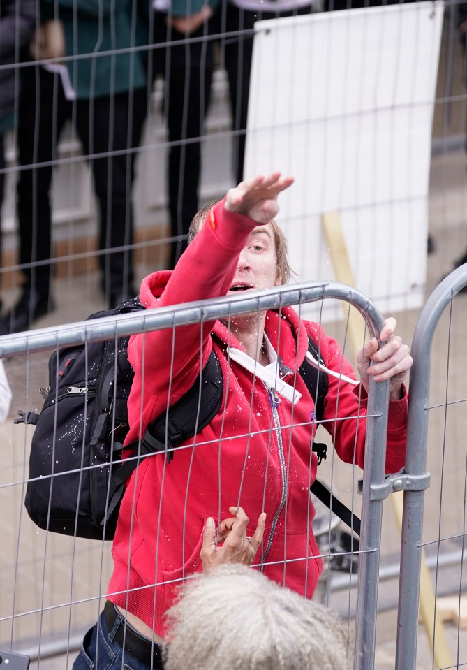 A man was pictured appearing to throw objects at Farage