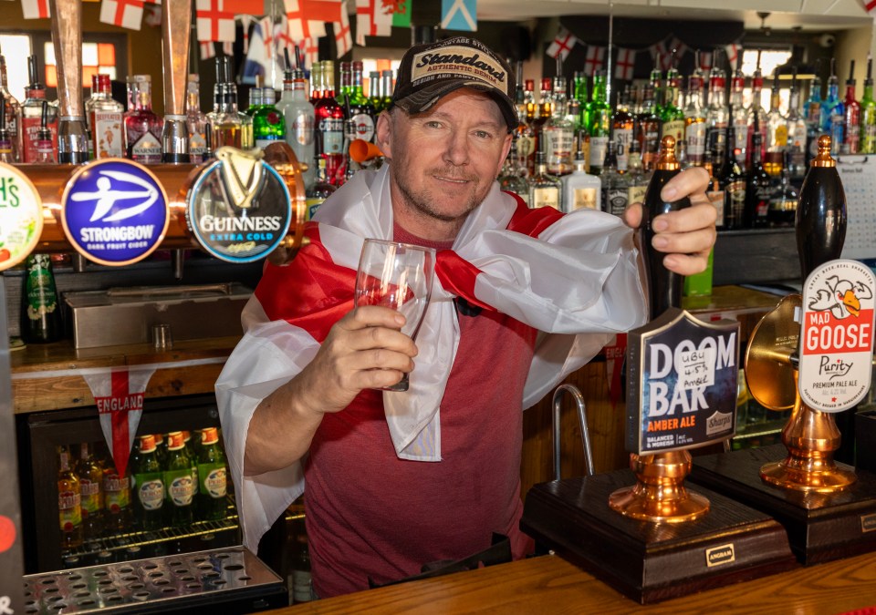 Owner Paul Kelly, 53, said: 'I’m a Gooner so I didn’t enjoy sticking up the signs but when it comes to England we’re all in it together'