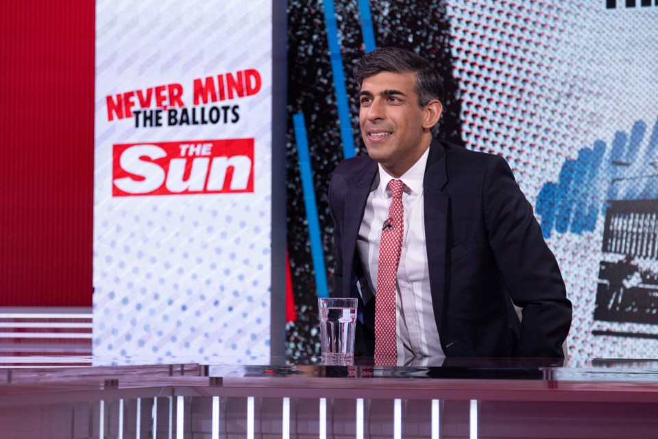 a man sitting in front of a sign that says never mind the ballots