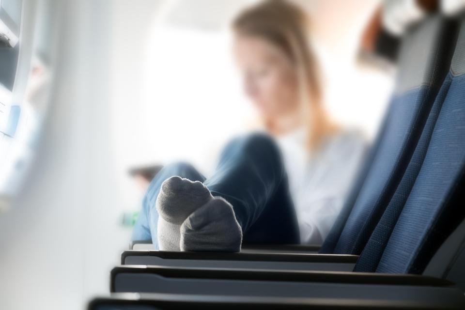 Either wear lighter socks on the flight - or keep your feet our of the aisle