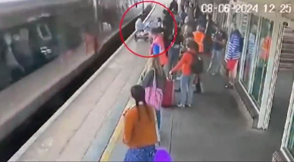 The heart-stopping moment a baby in a pram rolls into the side of a train after mum looks away for a split second