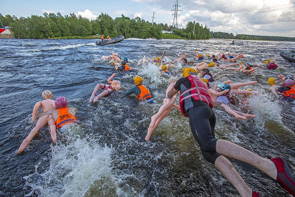 Dubbed the Bubble Baba Challenge, Russians swim through fast-flowing rapids in Leningrad with inflatable sex dolls helping them stay afloat