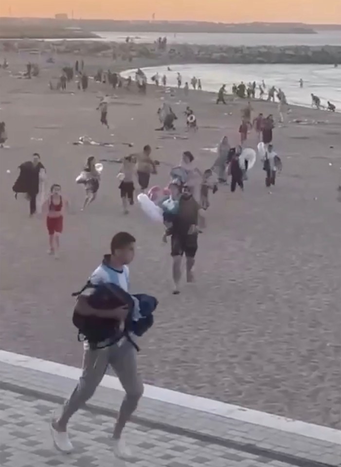 Terrified beachgoers run for their lives as cops  chase terrorists