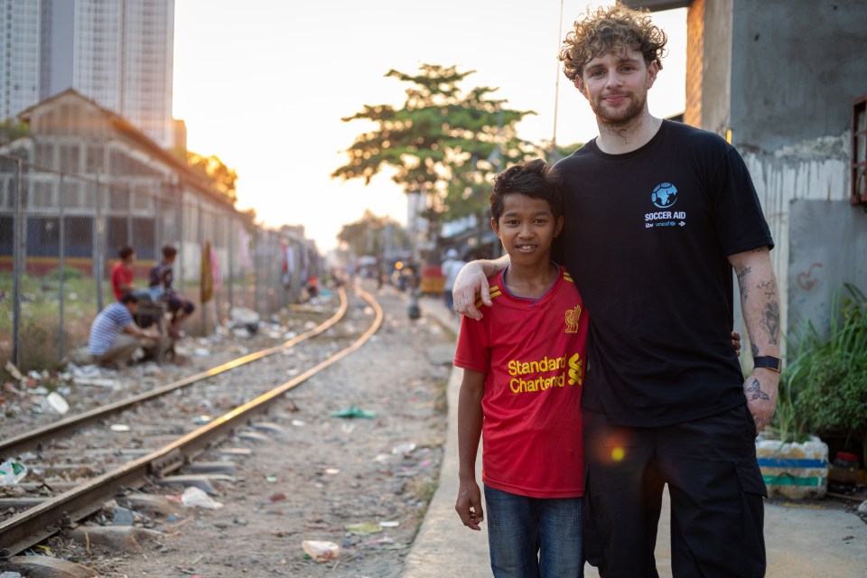 Singer Tom Grennan has travelled to Cambodia to meet youngsters due to benefit from Soccer Aid