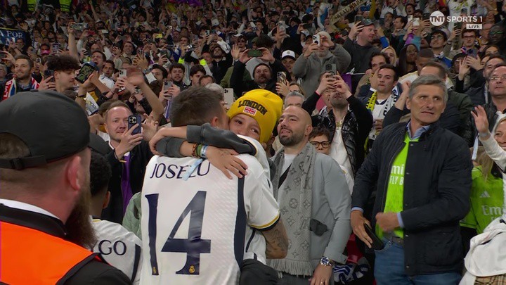 Real Madrid's Joselu hugs his emotional son after the club's Champions League win