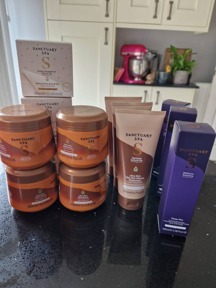 a stack of sanctuary spa products on a counter