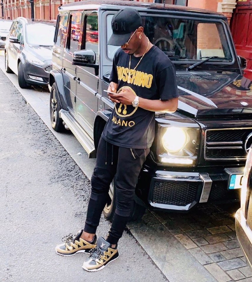 The Premier League midfielder pictured standing in front of his car wearing another of his luxury watches