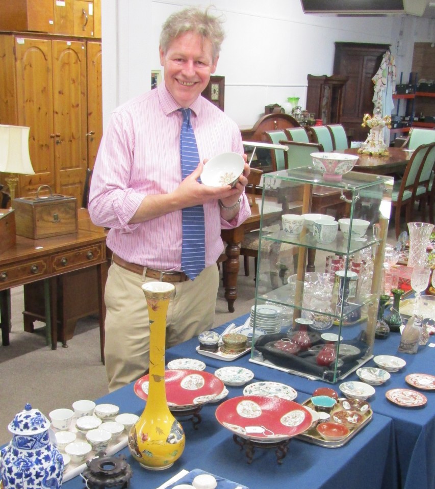 Auctioneer James Laverack with the collection that had been gathering dust in an attic for 20 years