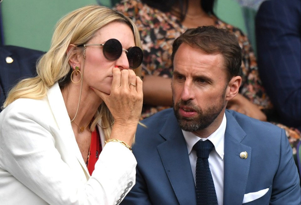 a man in a suit and tie sits next to a woman wearing sunglasses