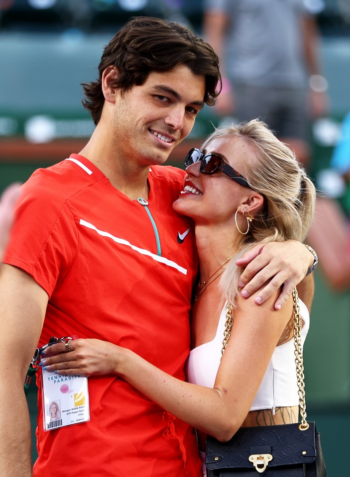 INDIAN WELLS, CALIFORNIA - MARCH 20: Taylor Fritz of the United States with his girlfriend Morgan Riddle after his straight sets victory against Rafael Nadal of Spain in the men's Final on Day 14 of the BNP Paribas Open at the Indian Wells Tennis Garden on March 20, 2022 in Indian Wells, California. (Photo by Clive Brunskill/Getty Images)