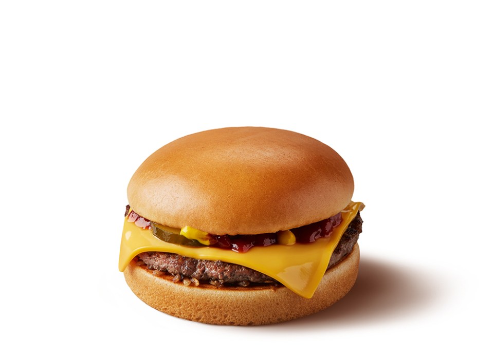 a hamburger with cheese and pickles on a bun