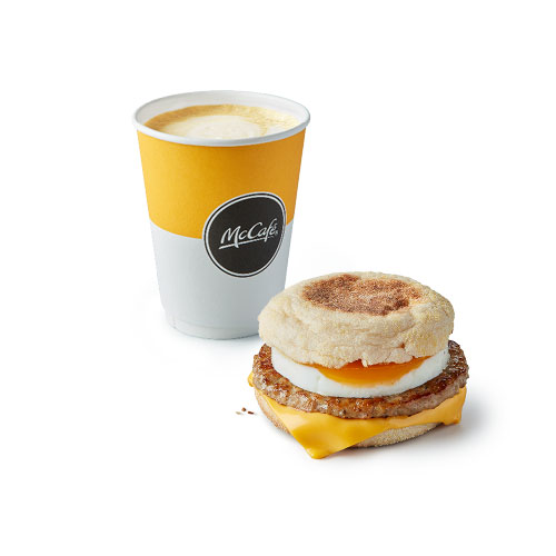 a mcdonald 's breakfast sandwich next to a cup of coffee