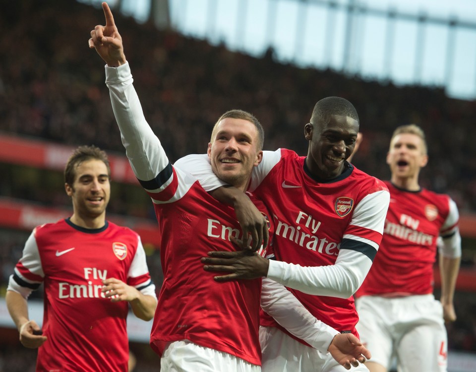 Sanogo, pictured here celebrating a goal with Lukas Podolski, helped Arsenal win the 2014 FA Cup