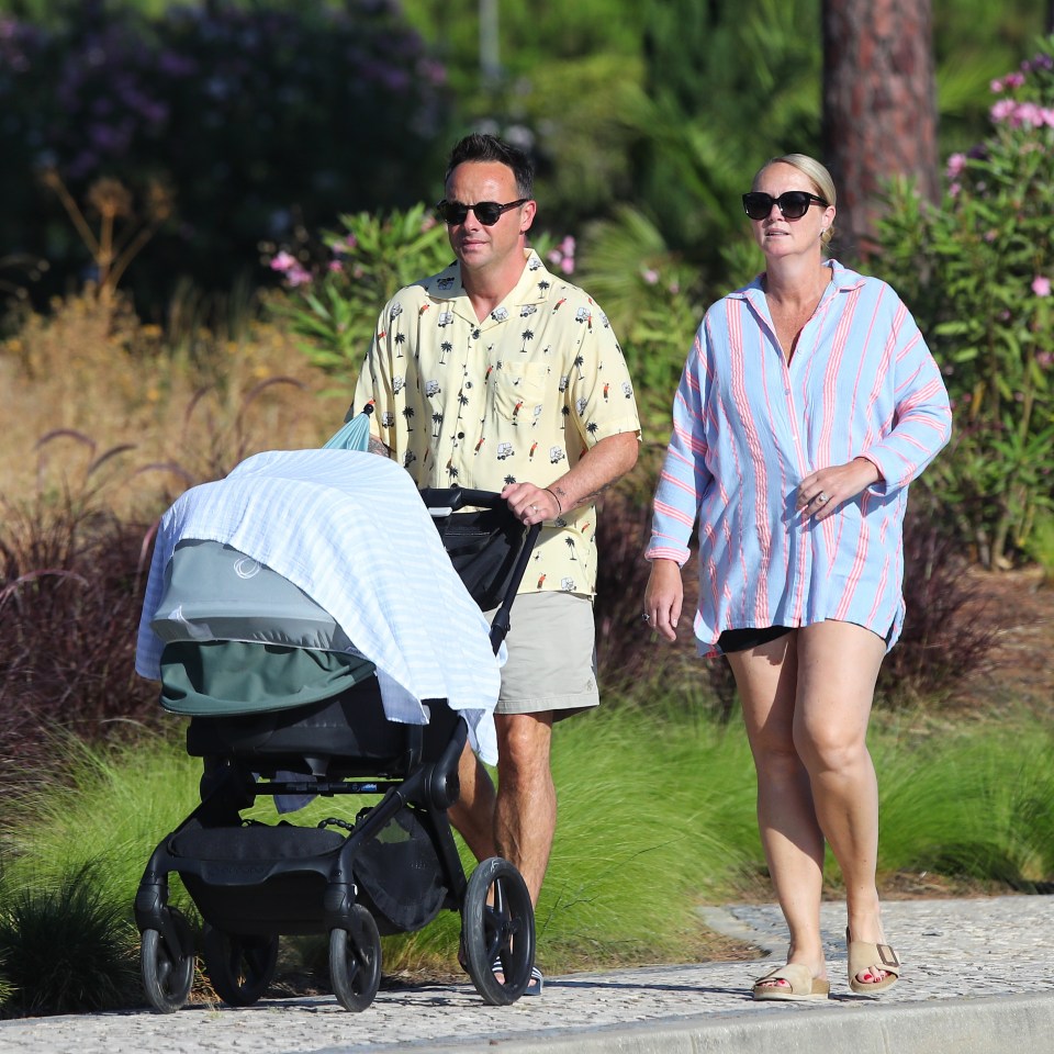 Ant wore a sunny shirt, shades and sliders for the family stroll