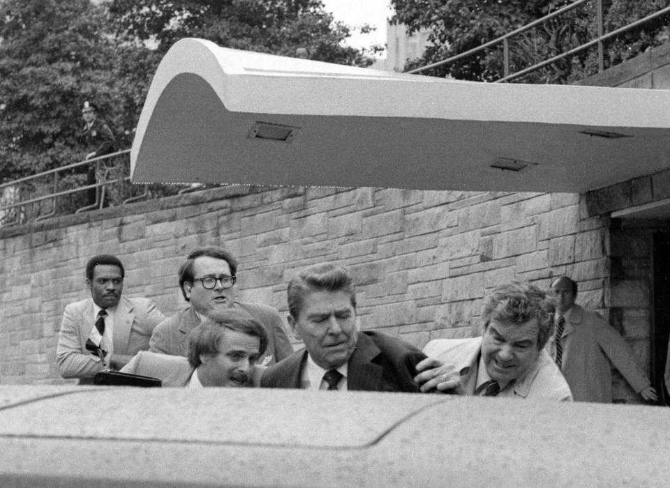 Reagan being shoved into the limousine after John Hinckley opened fire