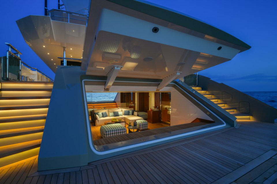 The back area of the yacht features a unique entry gate that opens up to the exquisite beach club