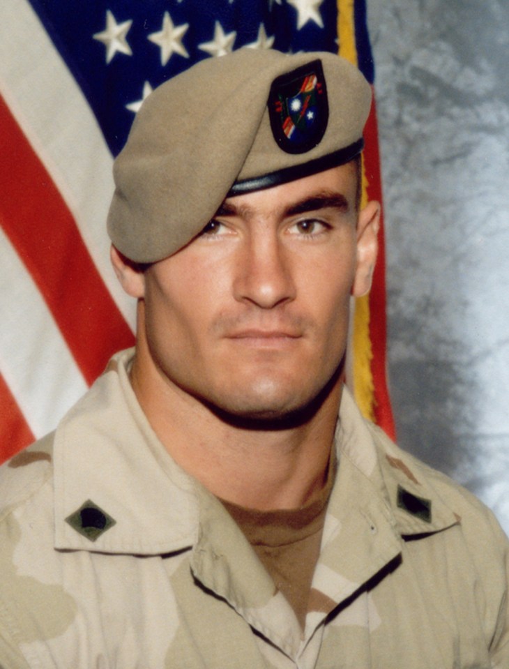 a man in a military uniform is wearing a tan beret