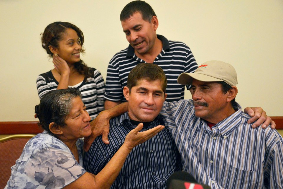 José (C) with dad Ricardo Orellana (R) and mum Maria Julia (L) and other family members during a news conference in San Salvador on February 18, 2014