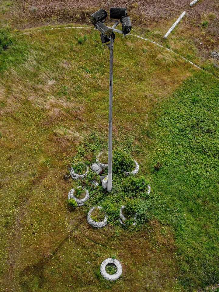 The floodlights are still standing but have been consumed by shrubbery