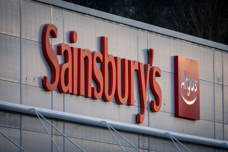 a sign for sainsbury 's is on the side of a building