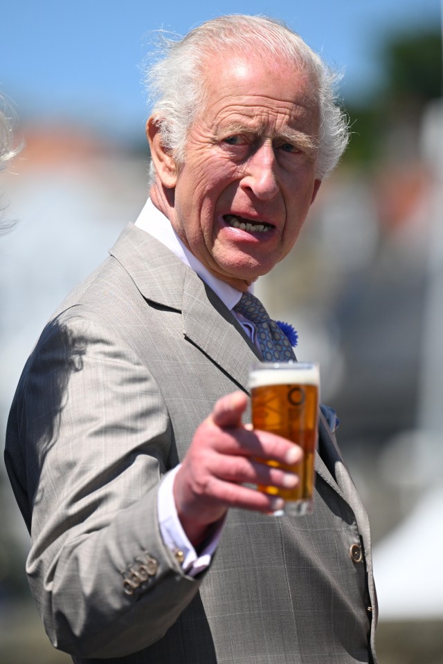 The King holding a drink of Charles Beer brewed for the Coronation