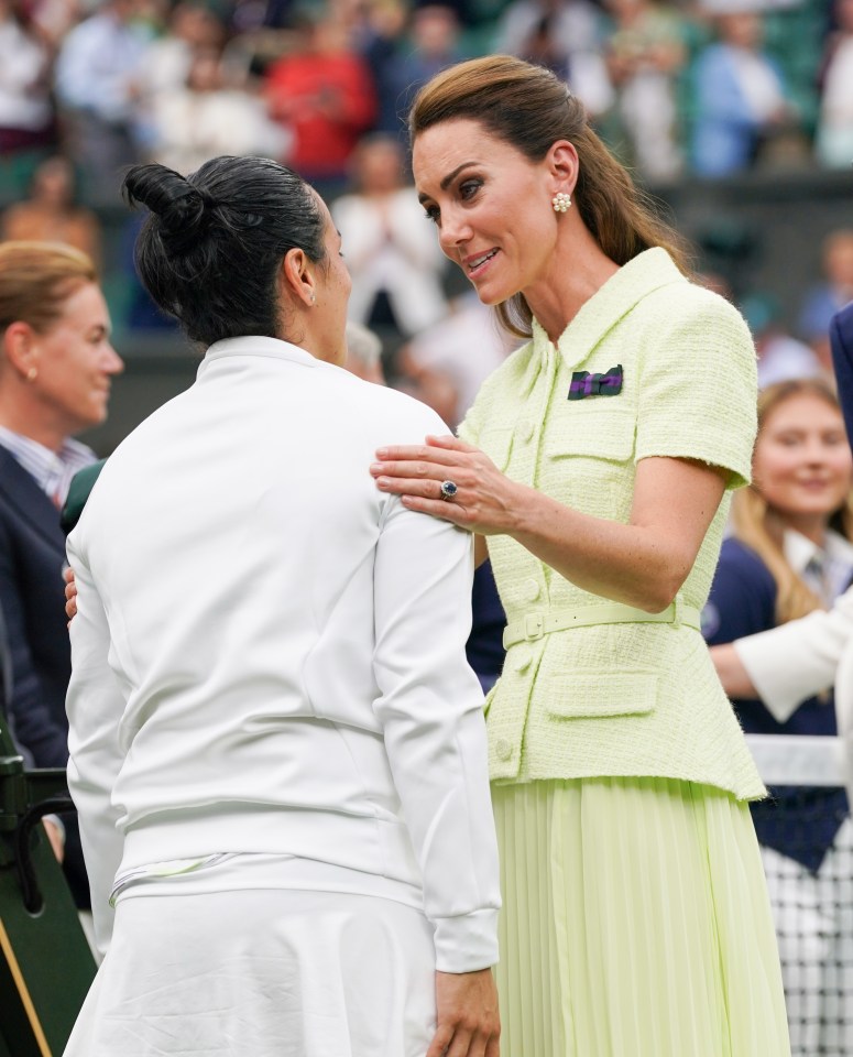 a woman in a yellow jacket talks to another woman in a white jacket