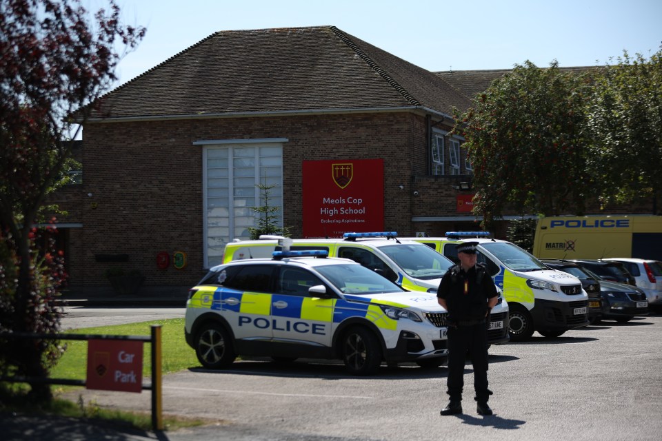 Police parked up at Meols Cop High School, which is being used as a base for police officers