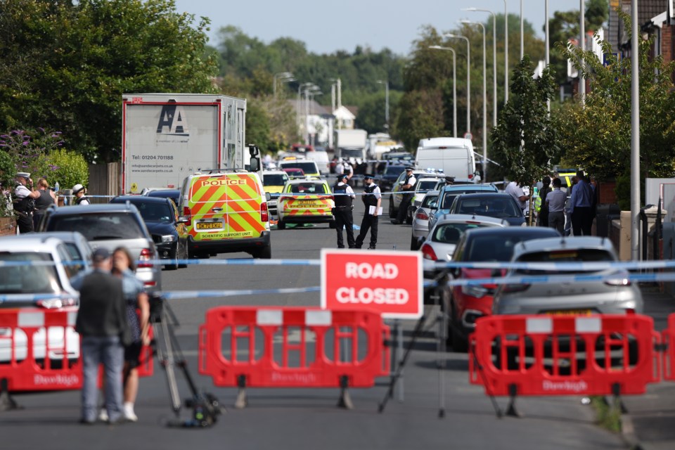 a busy street with a sign that says road closed