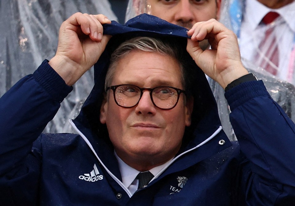 Starmer hid from the rain at the opening ceremony on Friday night