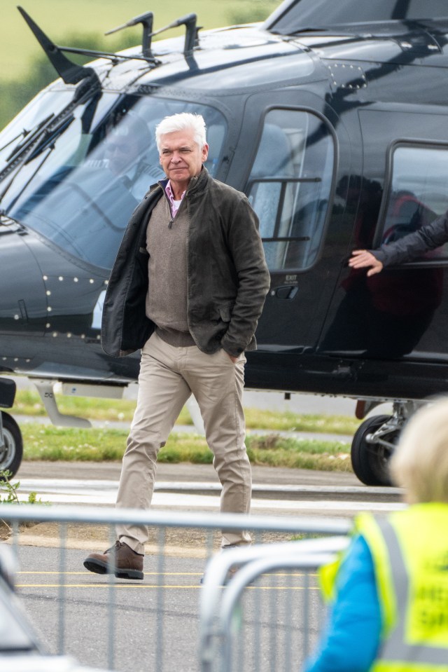 Philip Schofield made a rare public appearance as he arrived at the British Grand Prix by helicopter