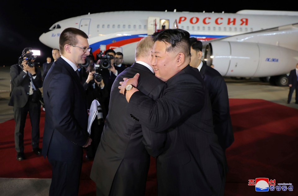 Russian President Vladimir Putin and North Korea’s leader Kim Jong Un, right, hug during the departure ceremony in  Pyongyang, North Korea