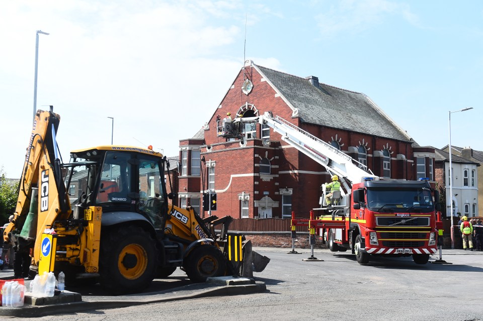 Fire crews remove broken windows at the Southport Islamic Society Mosque