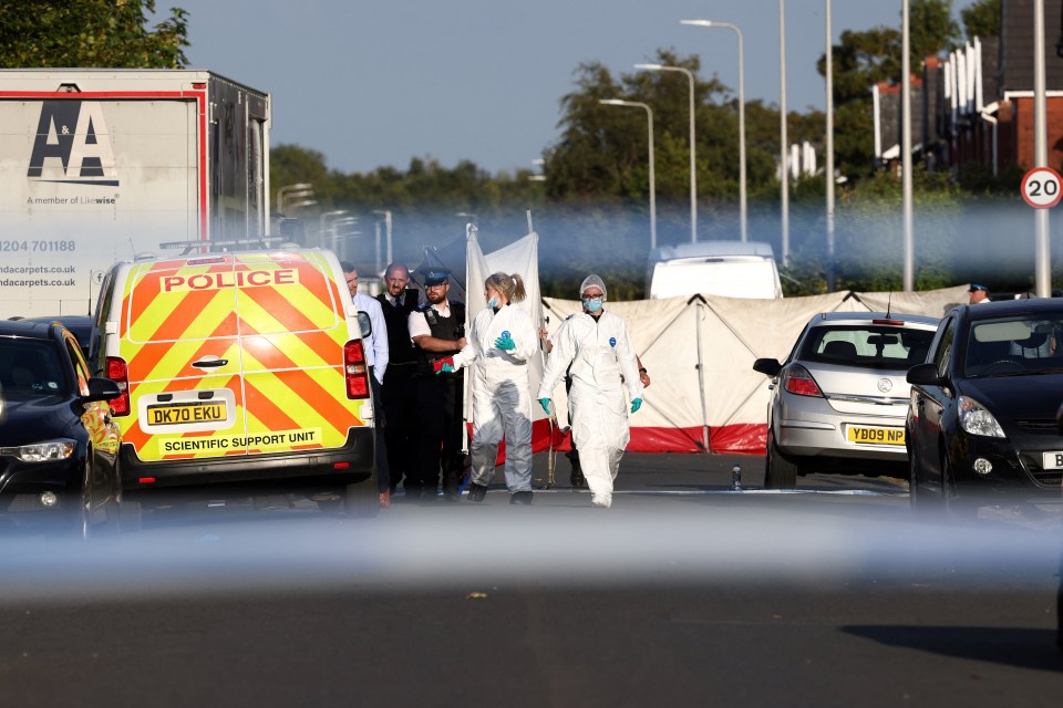 Forensics officers inside the cordon on Monday