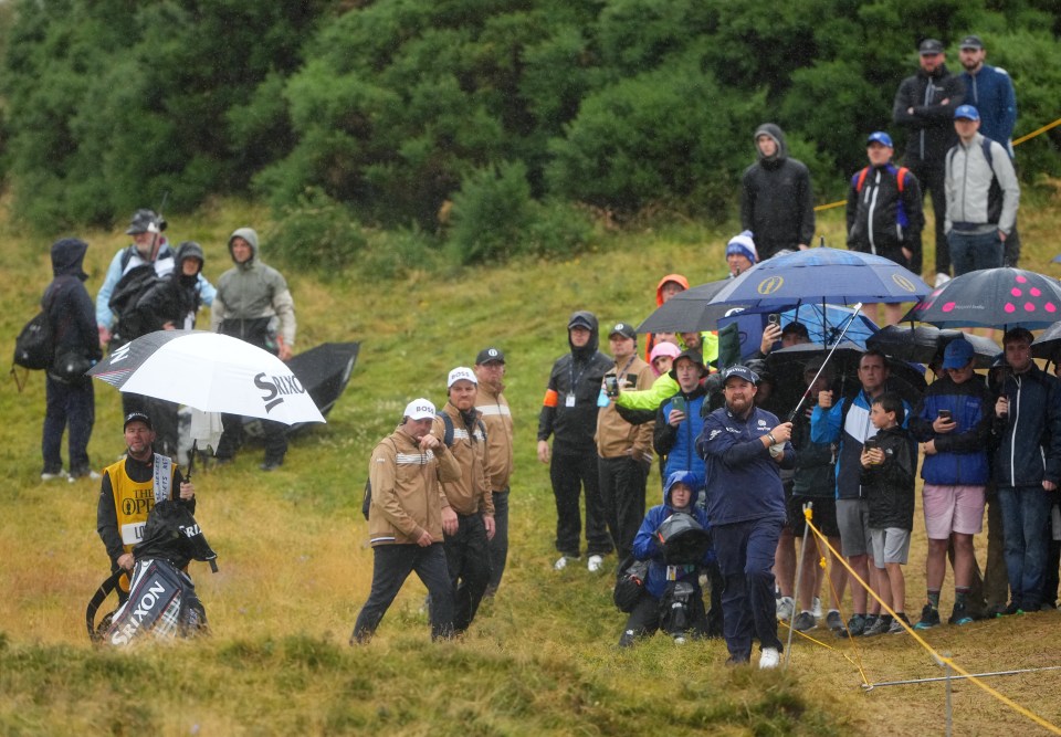 Shane Lowry looked jolly with a brolly high on the leaderboard