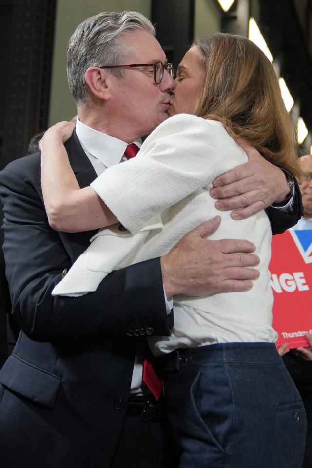 Sir Keir and Lady Starmer celebrate with a kiss