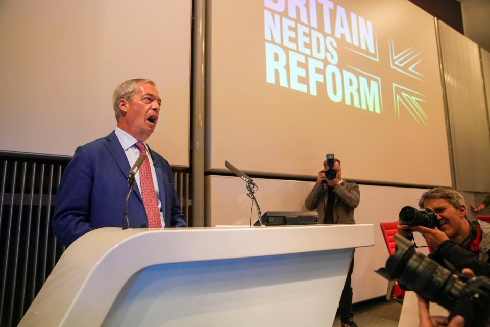 a man stands at a podium in front of a screen that says britain needs reform