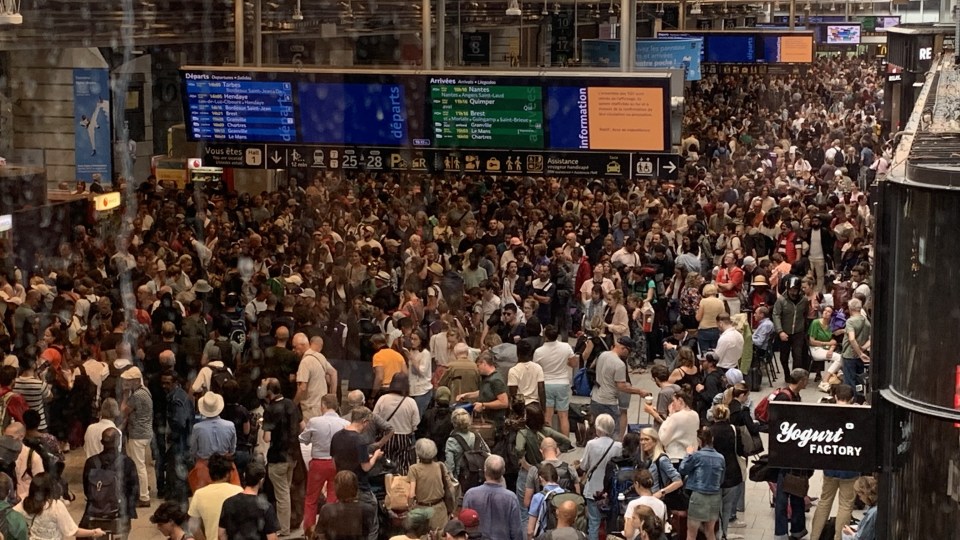 Passengers wait for their train departures at the Gare Montparnasse train station in Paris