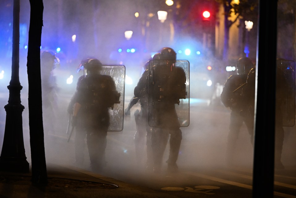 Masked rioters clash with riot police near Place de la Republique