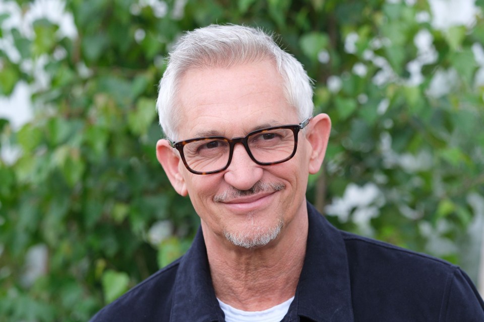 a man with glasses and a beard smiles for the camera