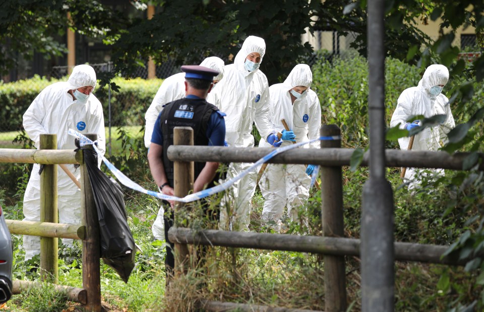 Forensic officers combing an area outside the barracks on Wednesday