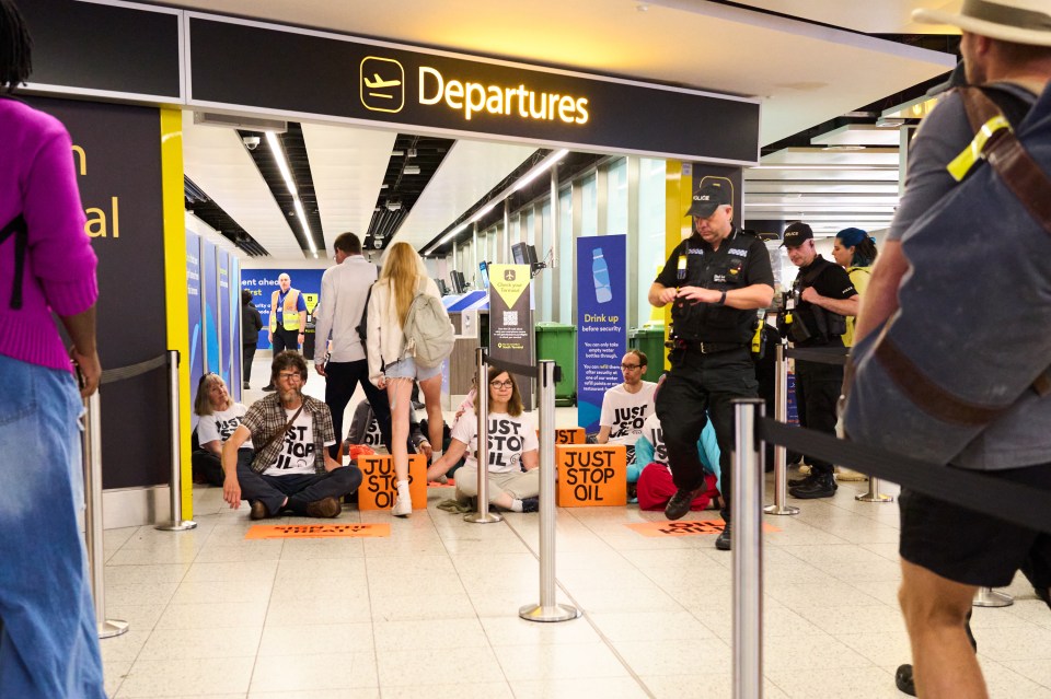 a group of people sitting in front of a sign that says departures